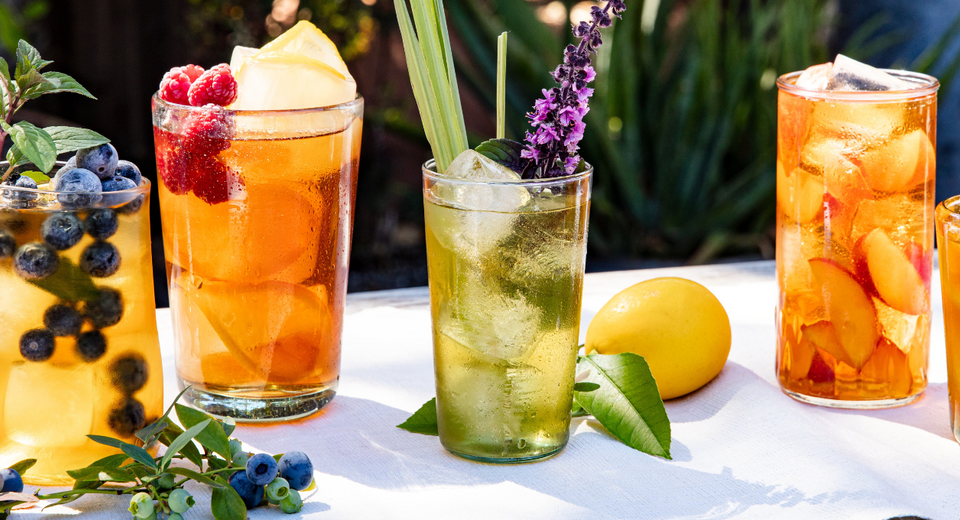 Various sparkling iced teas in glasses on a table