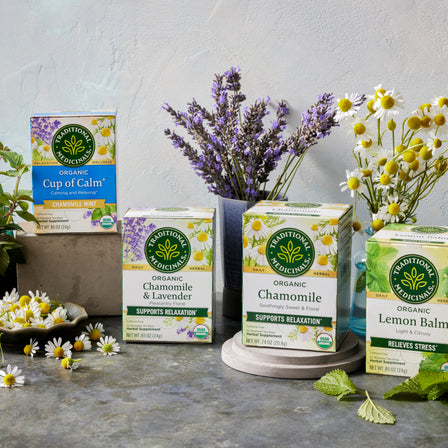 Various Traditional Medicinals tea boxes with fresh flowers around them