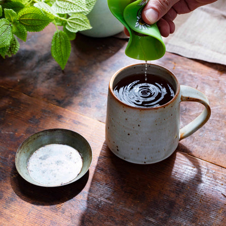 Gas Relief™ Tea with tea buddy squeezing tea bag on top