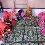 Indian women sewing coasters