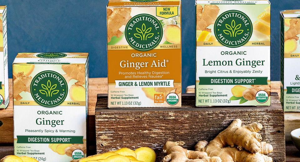 7 boxes of assorted Traditional Medicinals teas on table with ginger