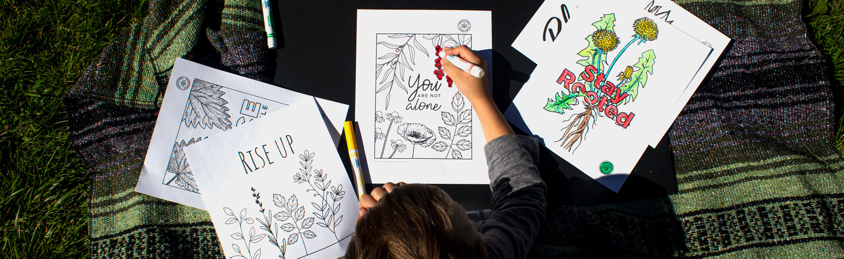 Child coloring in nature-inspired coloring book sheets