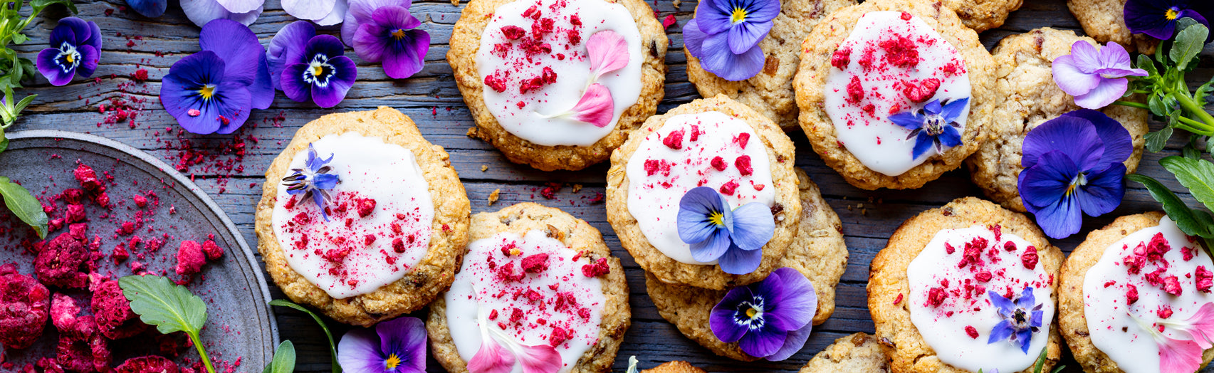 Beautiful array of herbal lactation cookies decorated with pink and purple edible flowers