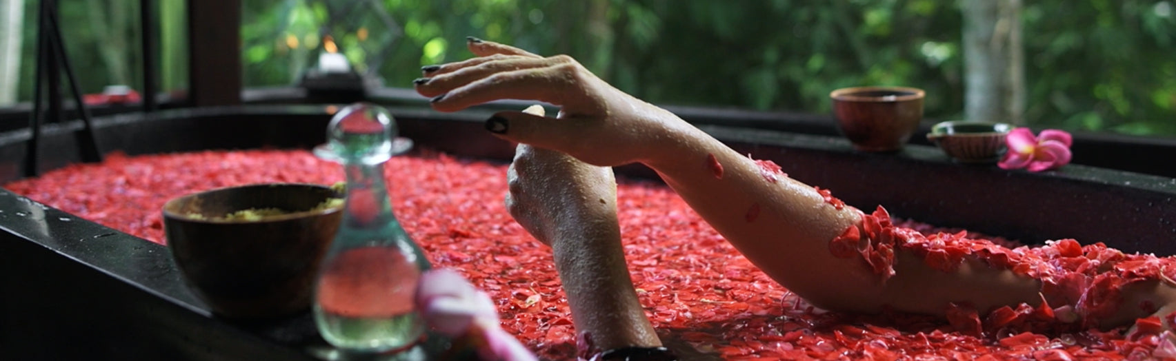 Woman in bath with rose petals