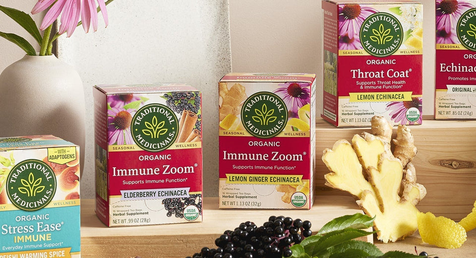 Seasonal tea boxes on a table with ginger and teapot