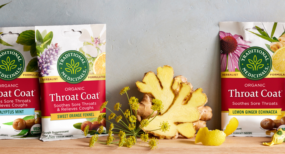 Throat Coat Lozenges bags on a table with ginger and flowers