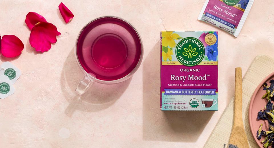 Rosy Mood Tea box, brewed tea in pot, and cup of rosy colored tea
